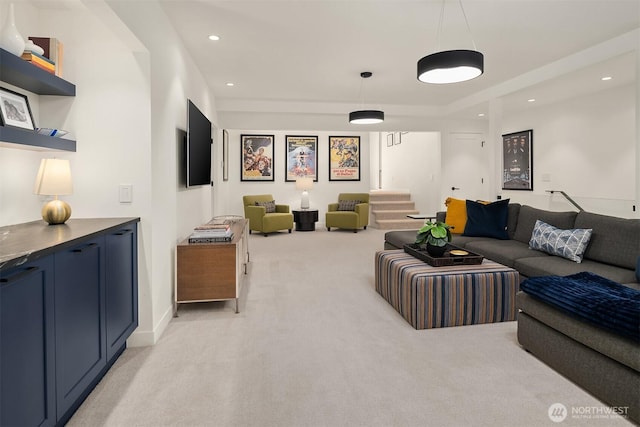 living area with light carpet, recessed lighting, and stairway