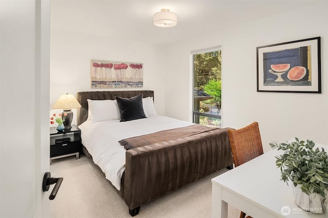 bedroom featuring light carpet