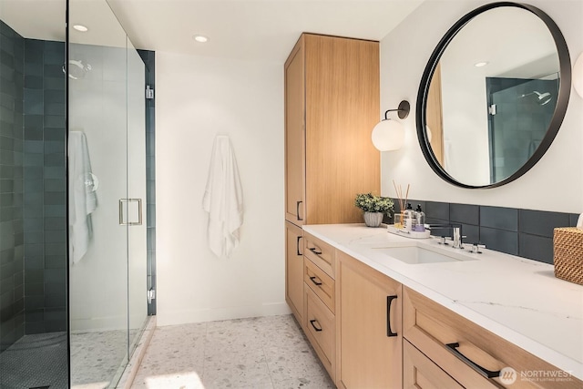 bathroom with a stall shower, baseboards, vanity, and recessed lighting