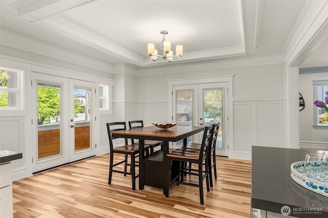 119 37th Ave E, Seattle, WA 98112 - dining space featuring plenty of natural light, a decorative wall, a notable chandelier, and french doors