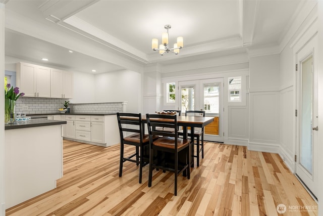 119 37th Ave E, Seattle, WA 98112 - dining room with a decorative wall, an inviting chandelier, light wood finished floors, ornamental molding, and recessed lighting