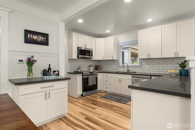 119 37th Ave E, Seattle, WA 98112 - kitchen featuring a sink, dark countertops, backsplash, crown molding, and appliances with stainless steel finishes