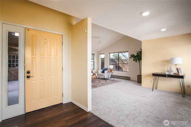 foyer with carpet floors, lofted ceiling, wood finished floors, baseboards, and a baseboard heating unit
