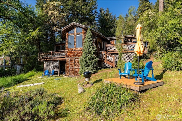 view of jungle gym with stairs, a yard, and a deck