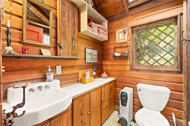 bathroom with vanity, wood walls, toilet, and wooden ceiling