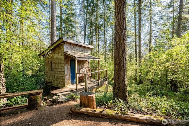 view of shed featuring a wooded view