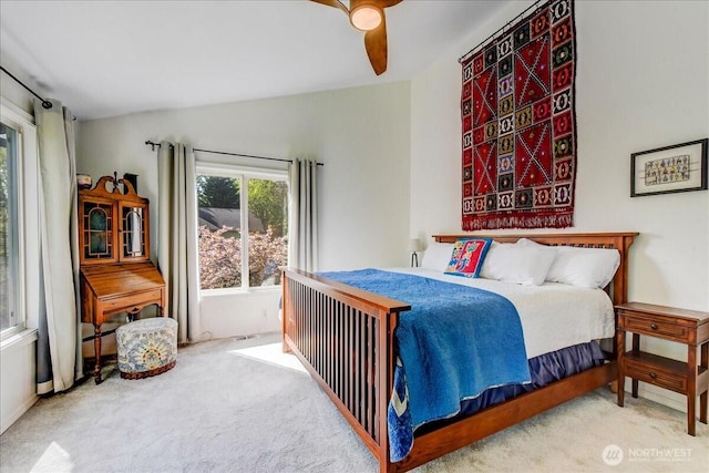bedroom with vaulted ceiling, carpet, and a ceiling fan
