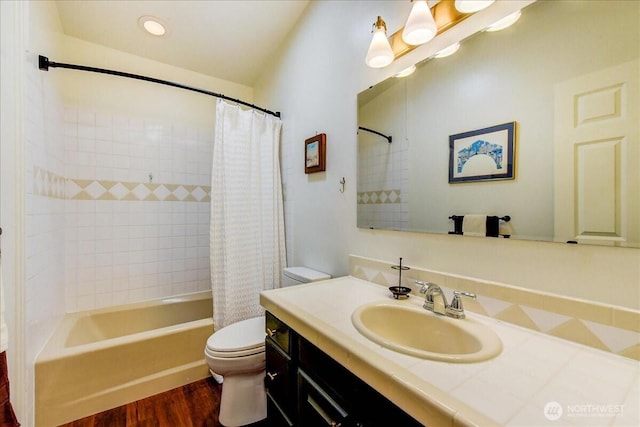 bathroom featuring shower / bath combo with shower curtain, wood finished floors, vanity, and toilet