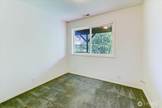 carpeted spare room with baseboards and visible vents