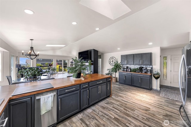 4353 Gooding Ave, Bellingham, WA 98226 - kitchen with an inviting chandelier, freestanding refrigerator, butcher block countertops, light wood-style floors, and recessed lighting