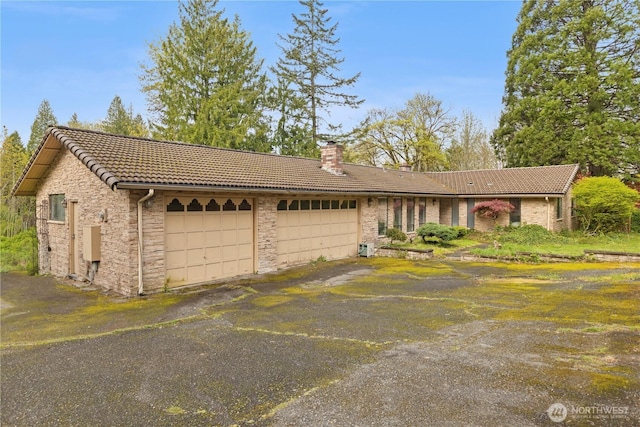 15324 SE 344th St, Auburn, WA 98092 - single story home with a tiled roof, stone siding, an attached garage, and a chimney