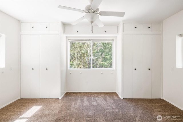 212 Deer Park Ln, Port Angeles, WA 98362 - unfurnished bedroom featuring multiple closets, baseboards, carpet, and ceiling fan
