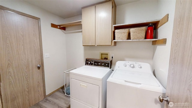 4713 Stikes Dr SE, Lacey, WA 98503 - clothes washing area featuring light wood-style flooring, independent washer and dryer, and cabinet space