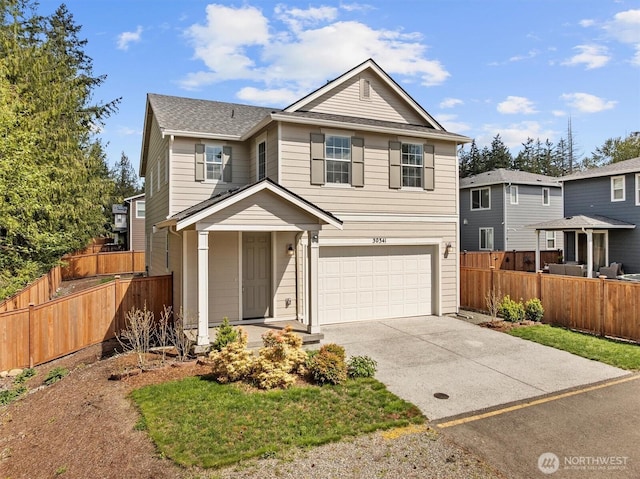 traditional home featuring a garage, fence, driveway, and roof with shingles