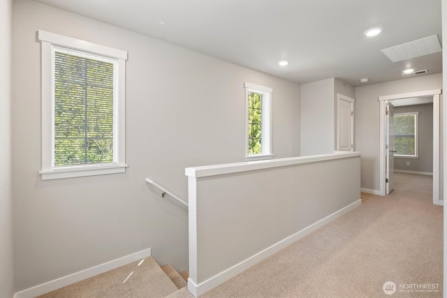 hall featuring light carpet, recessed lighting, baseboards, an upstairs landing, and visible vents