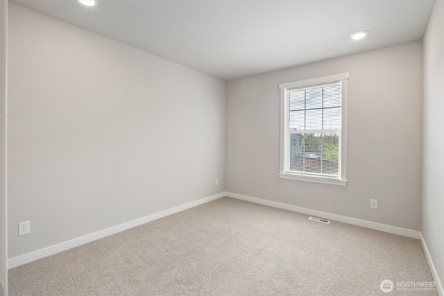 unfurnished room featuring recessed lighting, baseboards, visible vents, and carpet