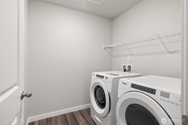 laundry area with laundry area, visible vents, dark wood-style flooring, baseboards, and washing machine and clothes dryer
