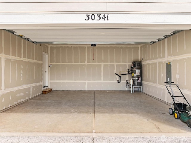 garage with water heater and electric panel