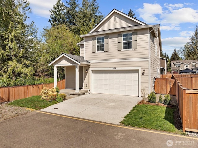 traditional home with fence, an attached garage, and driveway