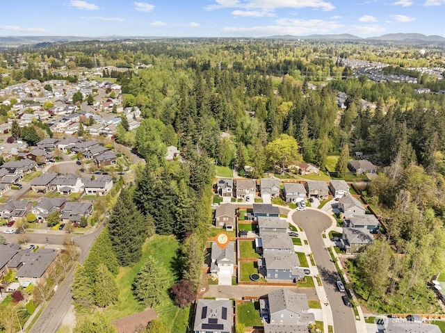 bird's eye view with a view of trees, a mountain view, and a residential view