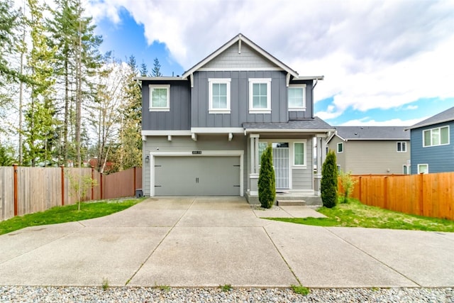 19825 152nd Street Ct SE, Bonney Lake, WA 98391 - view of front of house with board and batten siding, an attached garage, fence, and concrete driveway