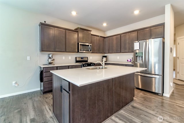 19825 152nd Street Ct SE, Bonney Lake, WA 98391 - kitchen with dark brown cabinets, wood finished floors, stainless steel appliances, and light countertops