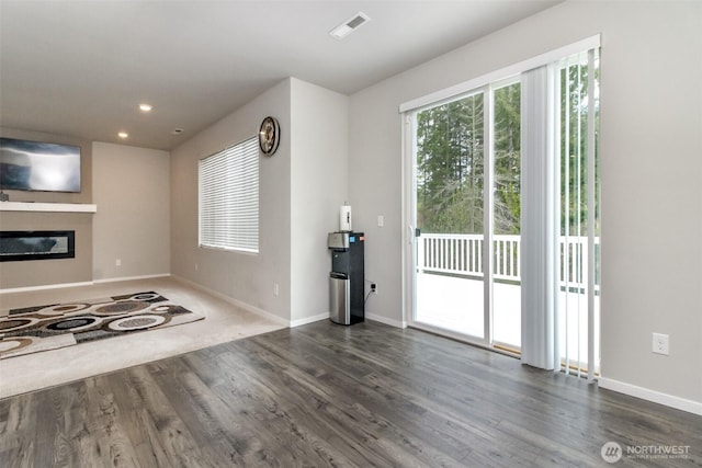 19825 152nd Street Ct SE, Bonney Lake, WA 98391 - unfurnished living room featuring baseboards, visible vents, and dark wood finished floors