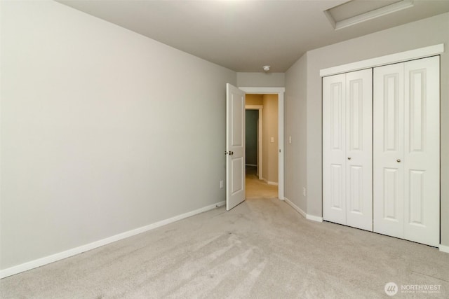 19825 152nd Street Ct SE, Bonney Lake, WA 98391 - unfurnished bedroom featuring attic access, baseboards, light colored carpet, and a closet