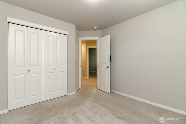 19825 152nd Street Ct SE, Bonney Lake, WA 98391 - unfurnished bedroom with light carpet, a closet, and baseboards