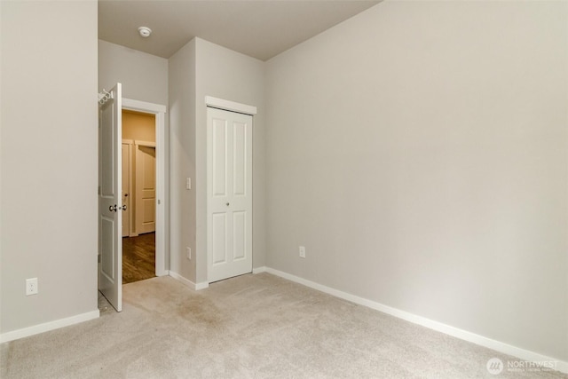 19825 152nd Street Ct SE, Bonney Lake, WA 98391 - unfurnished bedroom with light colored carpet, baseboards, and a closet