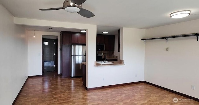 1953 S I St Unit 9, Tacoma, WA 98405 - kitchen featuring baseboards, stainless steel appliances, ceiling fan, and wood finished floors
