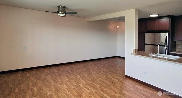1953 S I St Unit 9, Tacoma, WA 98405 - interior space with a ceiling fan, baseboards, a sink, and light wood-type flooring