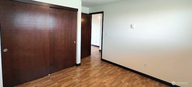 1953 S I St Unit 9, Tacoma, WA 98405 - unfurnished bedroom featuring baseboards, a closet, and light wood finished floors