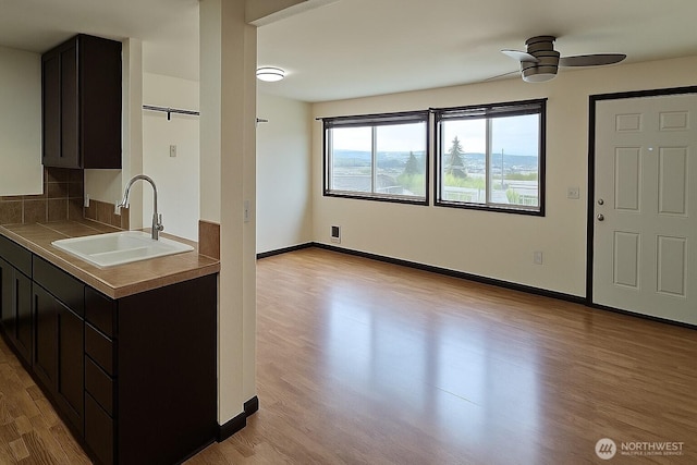 1953 S I St Unit 9, Tacoma, WA 98405 - kitchen with a sink, tile counters, a ceiling fan, and wood finished floors