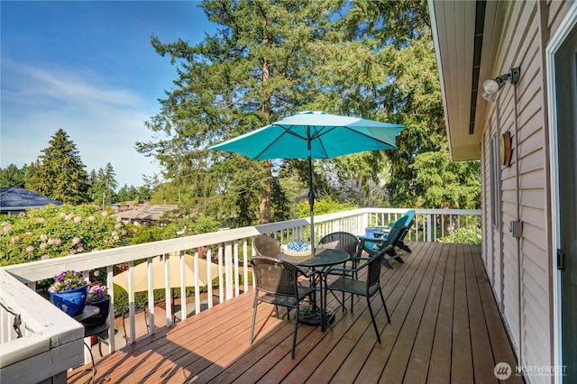 wooden terrace featuring outdoor dining space