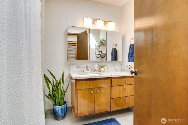 bathroom featuring tile patterned flooring and vanity