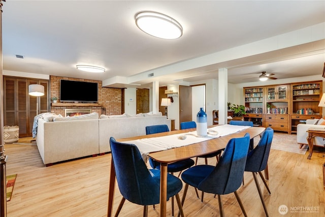 dining area featuring visible vents and light wood-style floors