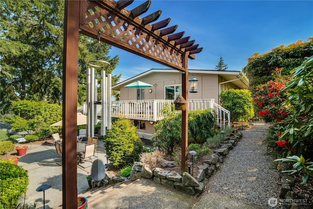view of patio with a pergola and a wooden deck