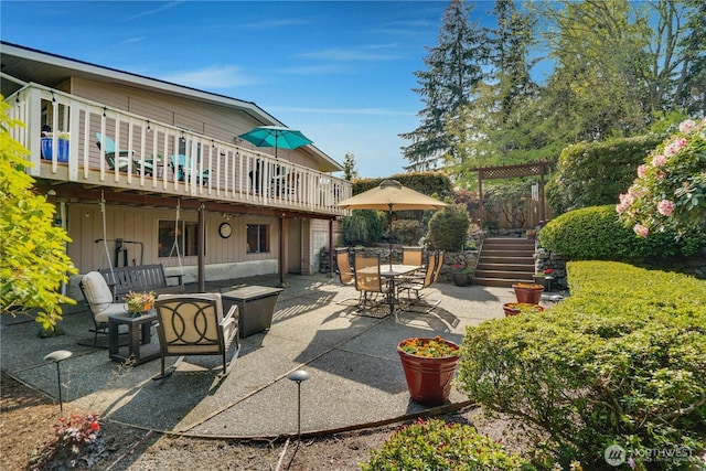 view of patio featuring a wooden deck, stairs, outdoor dining area, and outdoor lounge area
