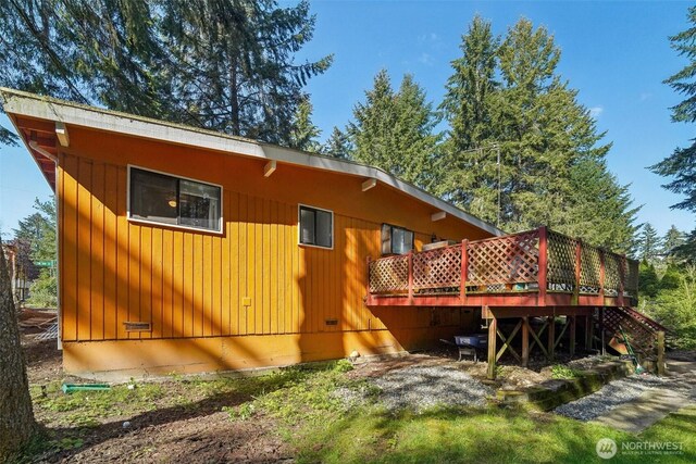 rear view of house featuring a deck