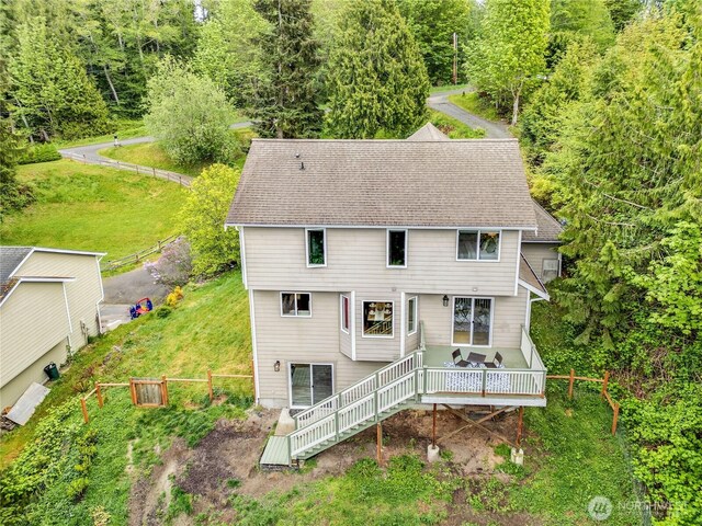 back of house featuring fence, a deck, and stairway