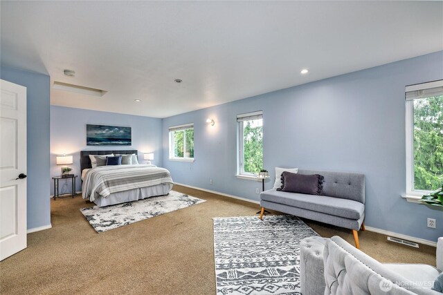 carpeted bedroom with baseboards, multiple windows, recessed lighting, and visible vents