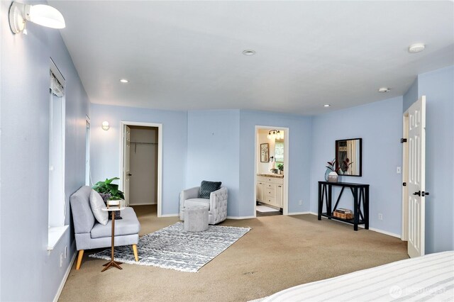 carpeted bedroom featuring baseboards, recessed lighting, ensuite bath, and a spacious closet