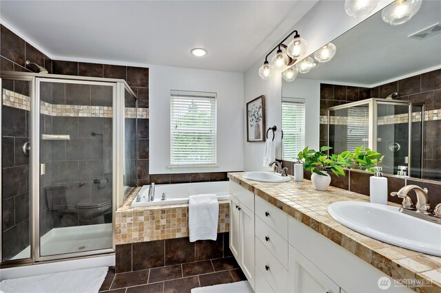 full bath featuring visible vents, a sink, a bath, and a stall shower