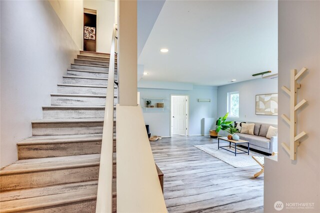 stairway featuring recessed lighting and wood finished floors