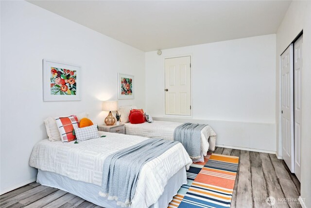 bedroom featuring a closet and wood finished floors