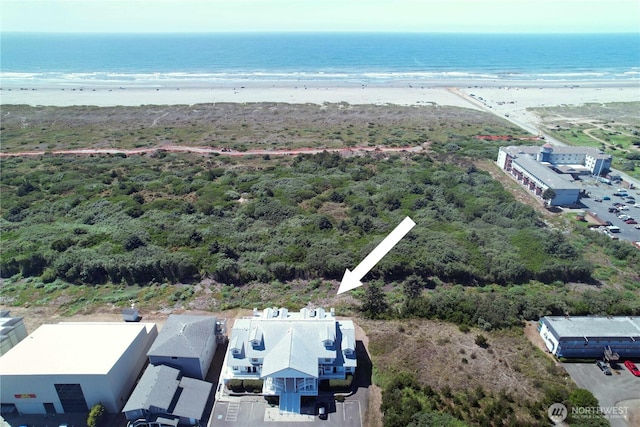 drone / aerial view featuring a beach view and a water view