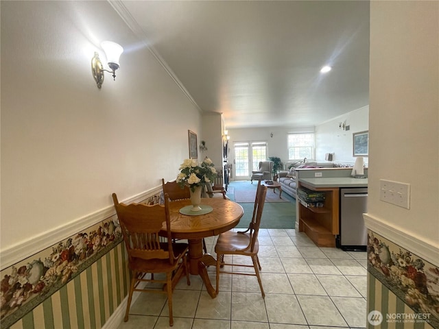 dining space featuring light tile patterned floors and ornamental molding