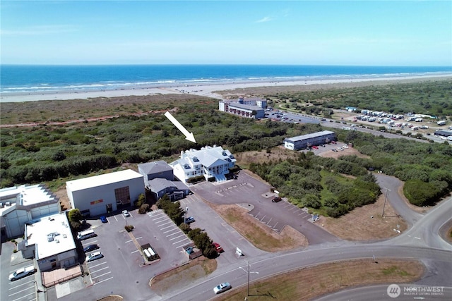 birds eye view of property with a water view and a view of the beach