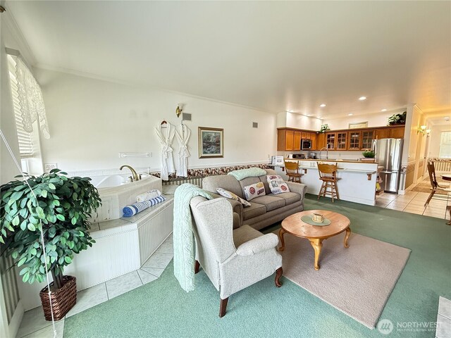living room with light tile patterned flooring, crown molding, recessed lighting, and light carpet